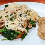 Chicken breasts smothered with Asiago cheese, spinach and mushrooms.