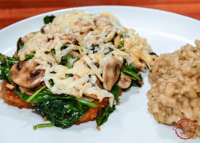 Chicken breasts smothered with asiago cheese, spinach and mushrooms.