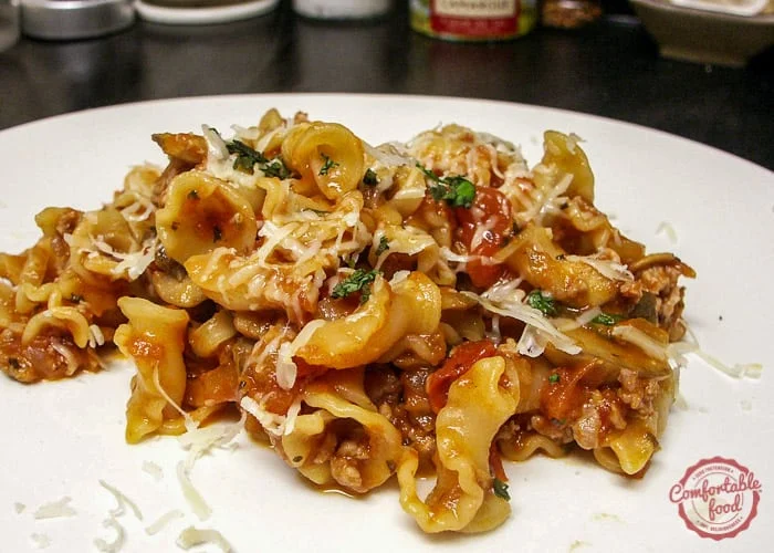 Hearty pasta with sausage and tomatoes recipe.