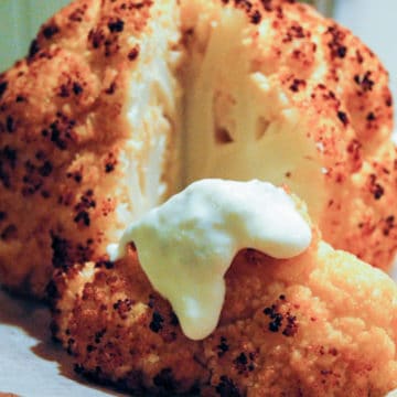 A recipe for roasted cauliflower with herbed cheese sauce.
