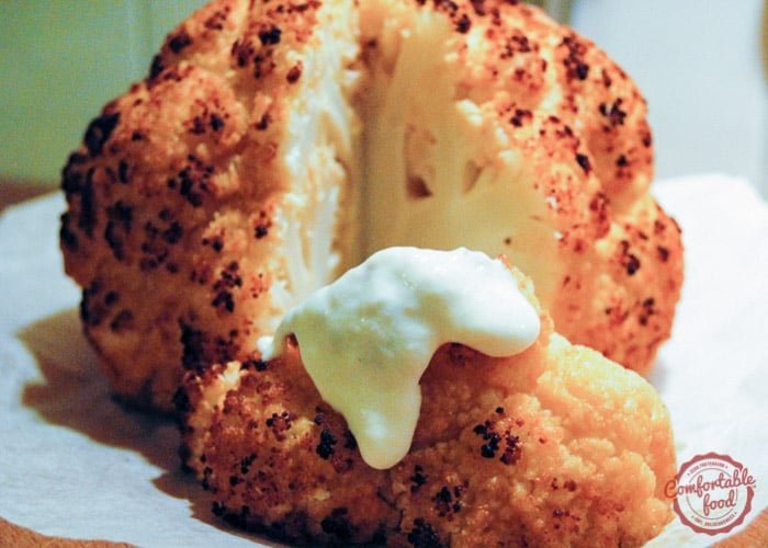 A recipe for roasted cauliflower with herbed cheese sauce.