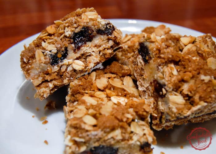 3 squares of recipe for triple good bars on white plate