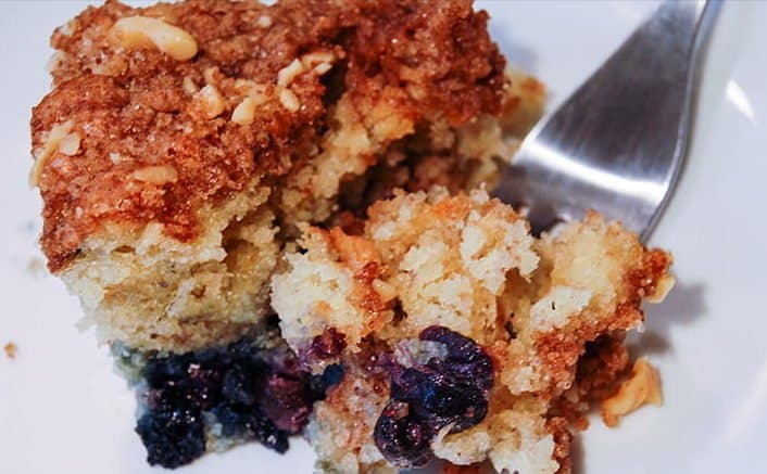 A rich dense coffee cake with sour cream and blueberries.