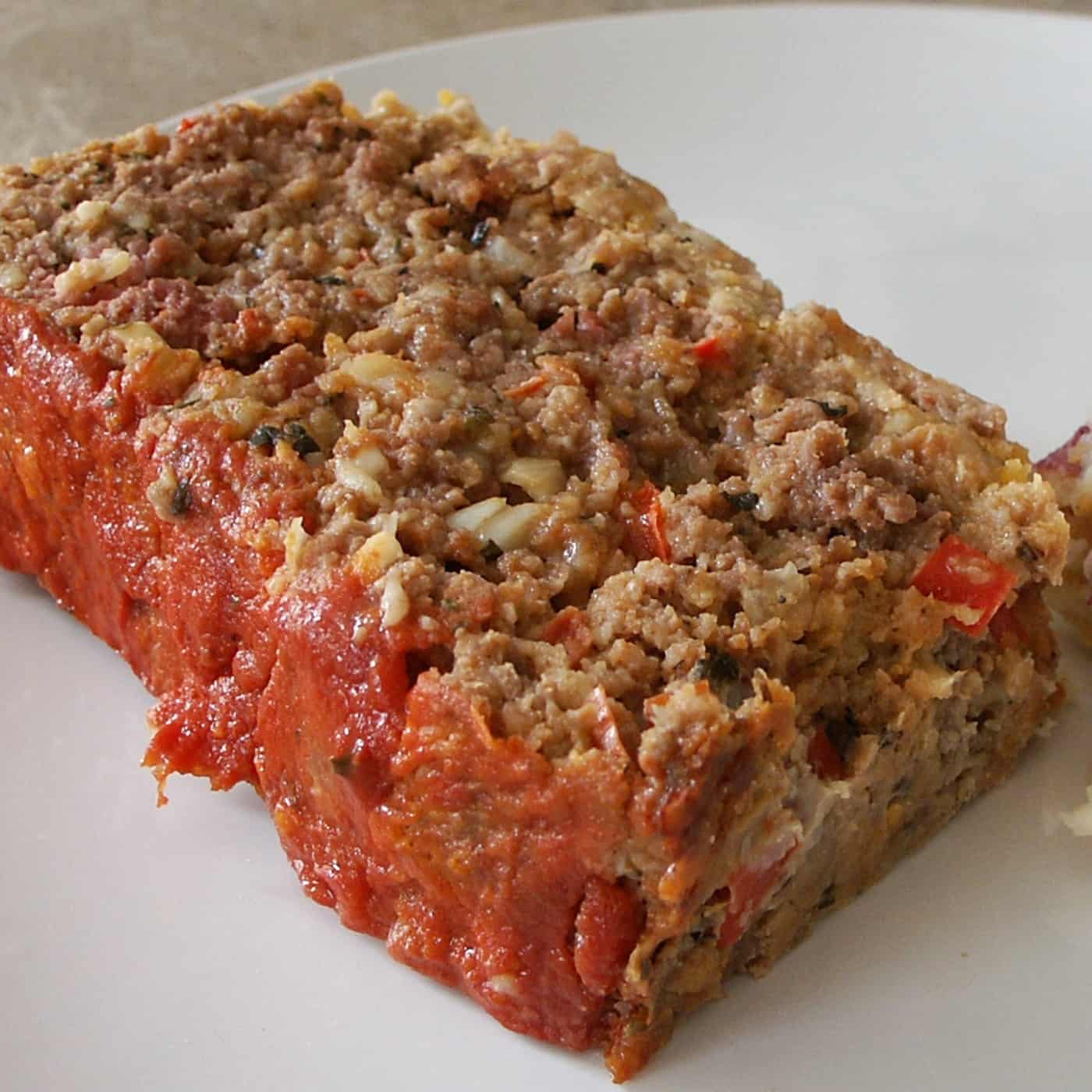 Sliced of italian meatloaf  with marinara sauce on top