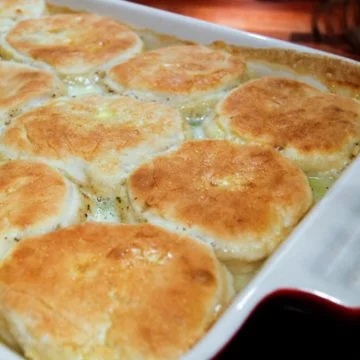 chicken and biscuits in a red casserole