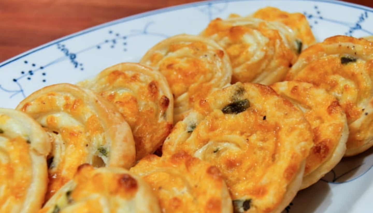 Baked Jalapeno Pinwheels 3 Several jalapeño popper pinwheels served on a white plate