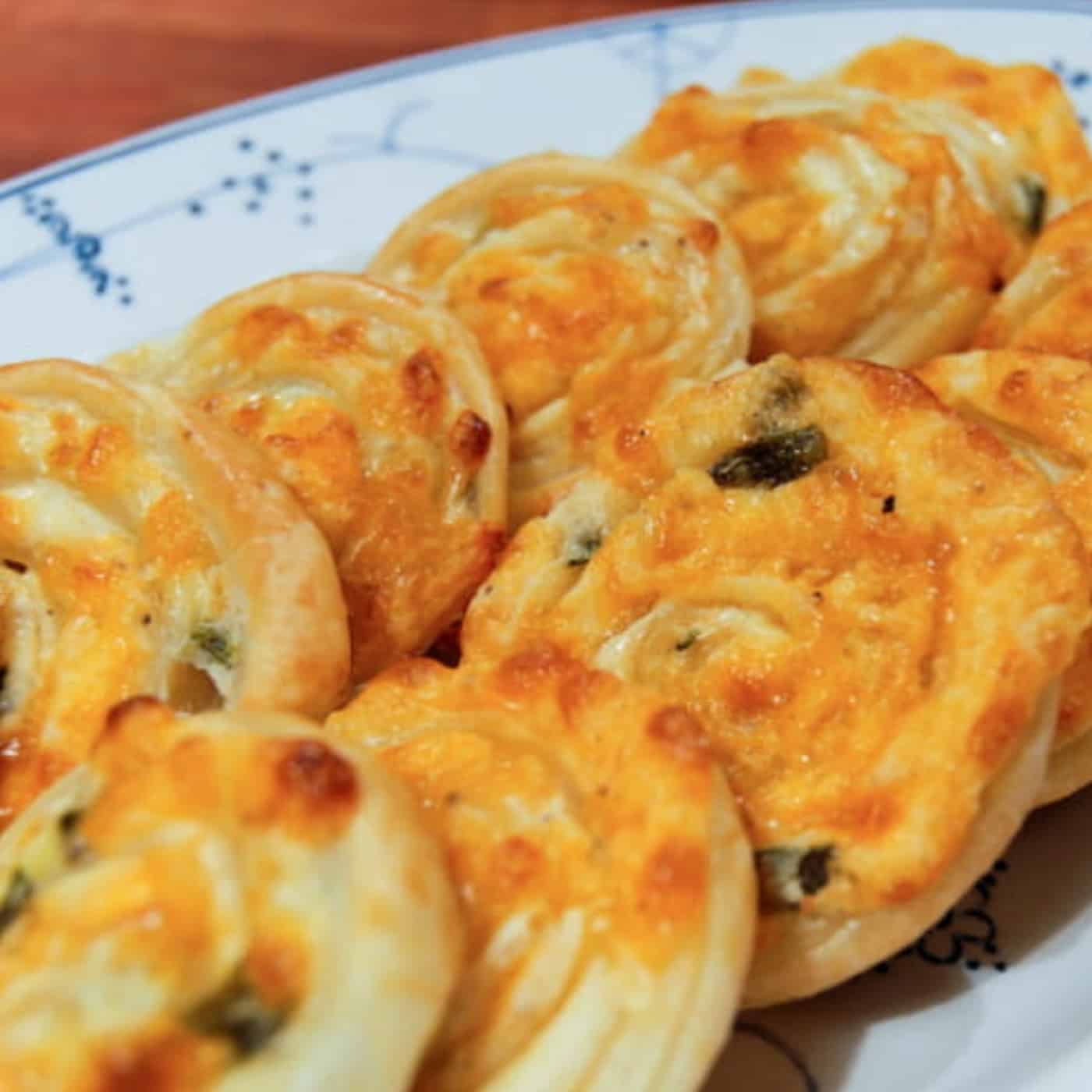 Baked Jalapeno Pinwheels 2 Jalapeño popper pinwheels served on a white plate