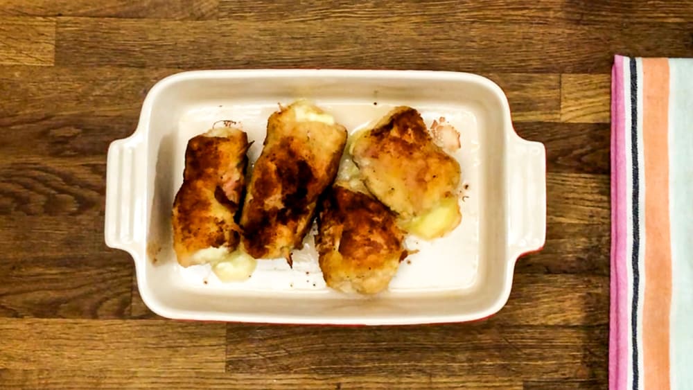 chicken cordon bleu seared in a baking pan
