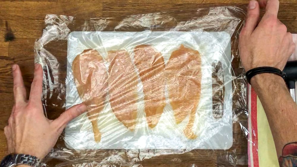 place each of the individual chicken breasts between 2 pieces of plastic wrap