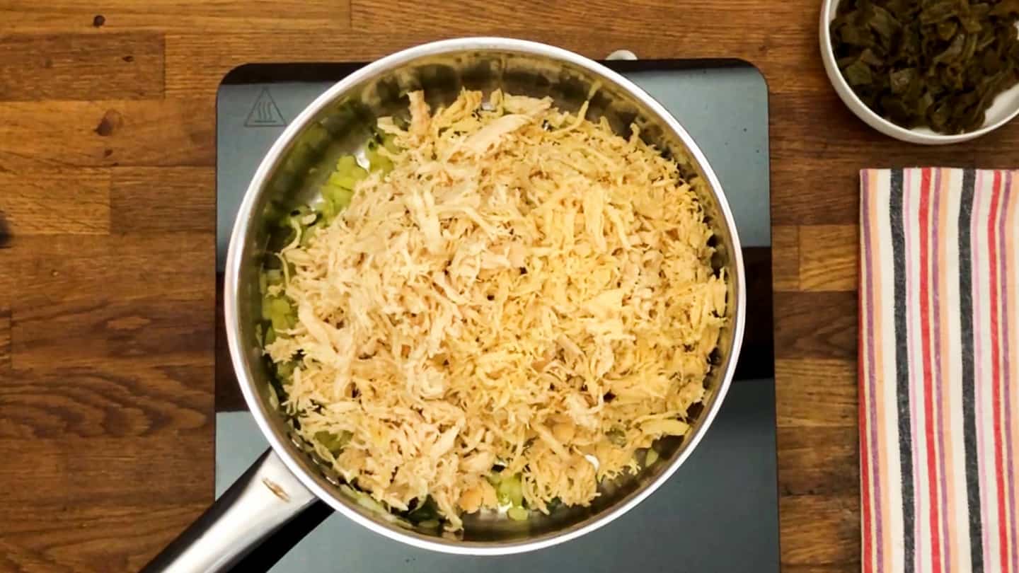 shredded chicken cooking in a pan