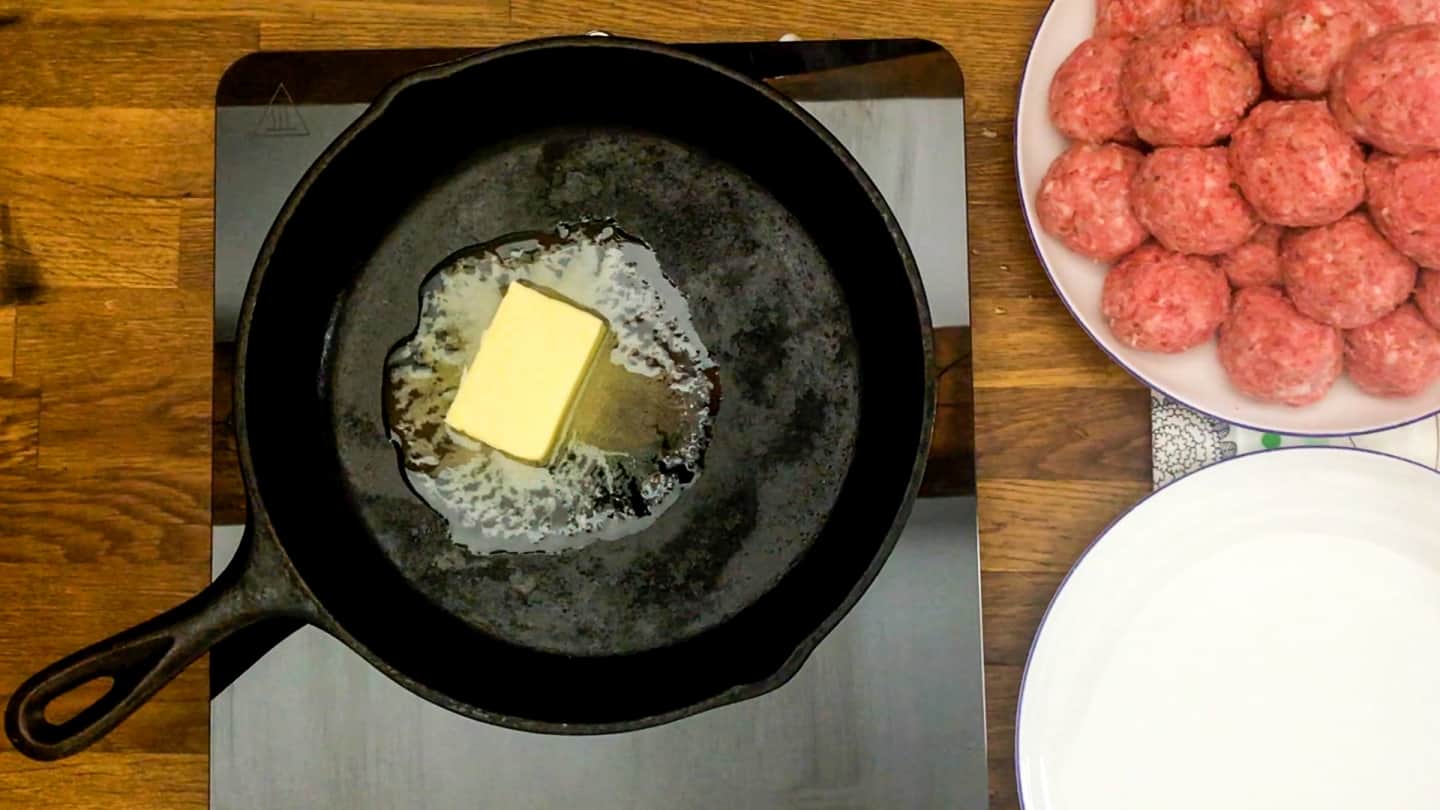 Large cast iron skillet with butter on medium heat (butter melting in pan)