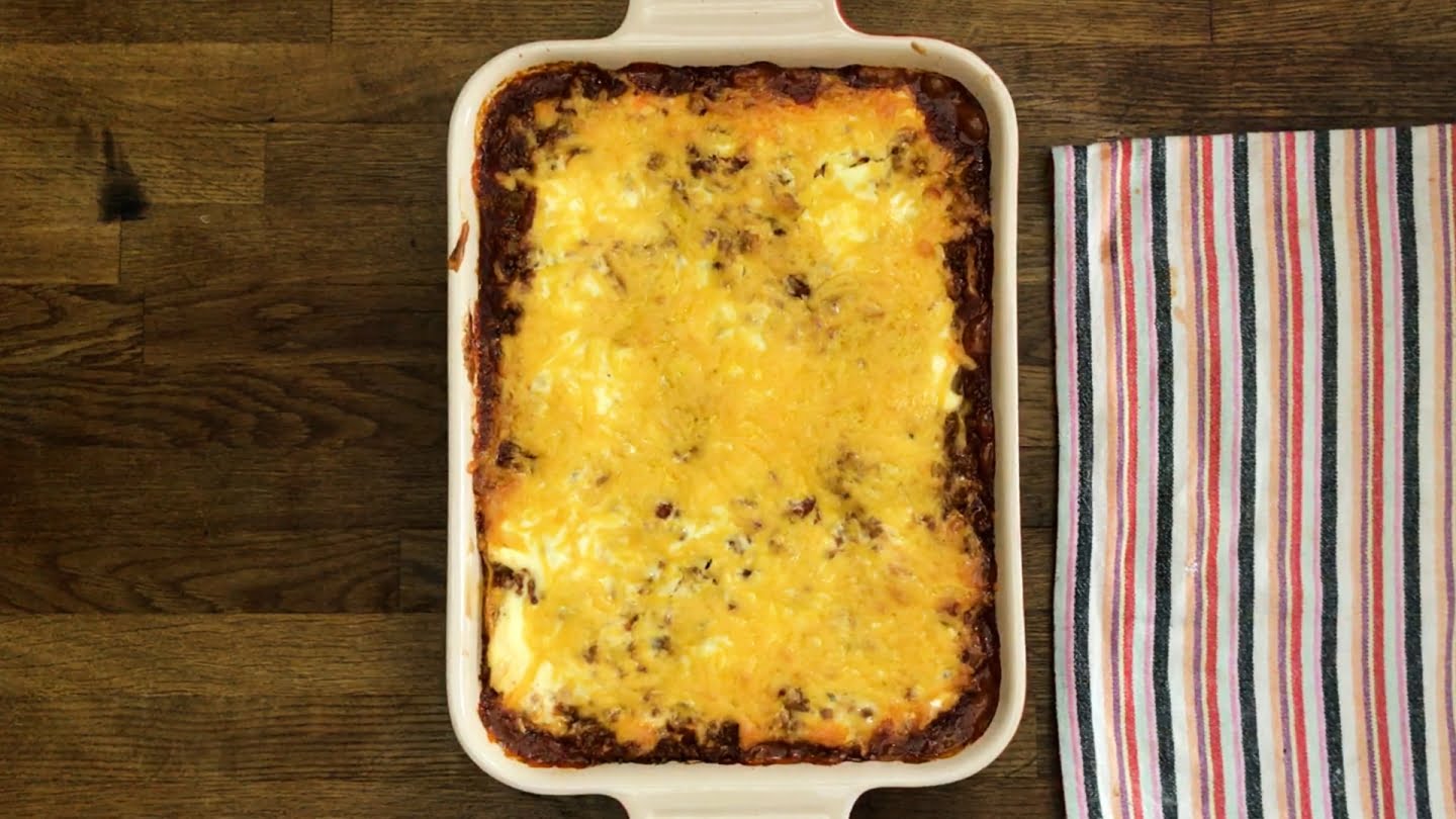 Mexican lasagna loaded with shredded cheddar cheese