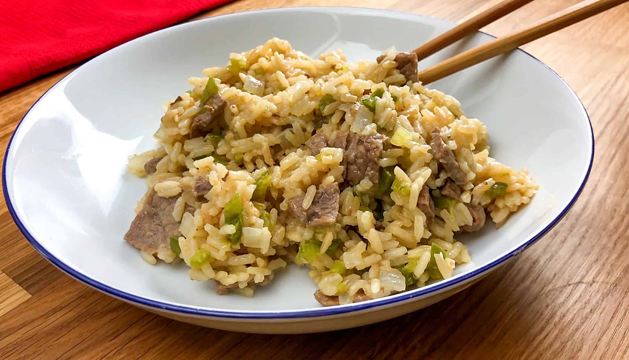 beef fried rice serve on white plate and chopsticks