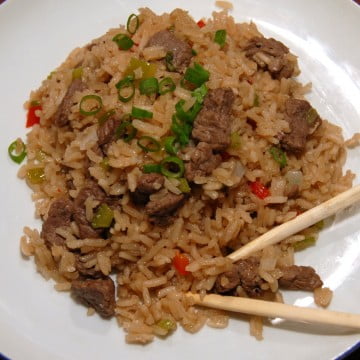 beef fried rice serve with green onion and chopsticks