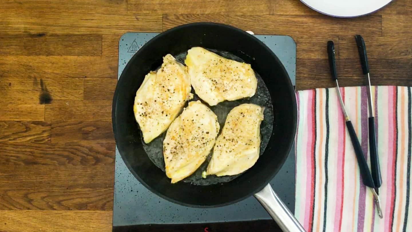  four chicken breast cooking in large skillet