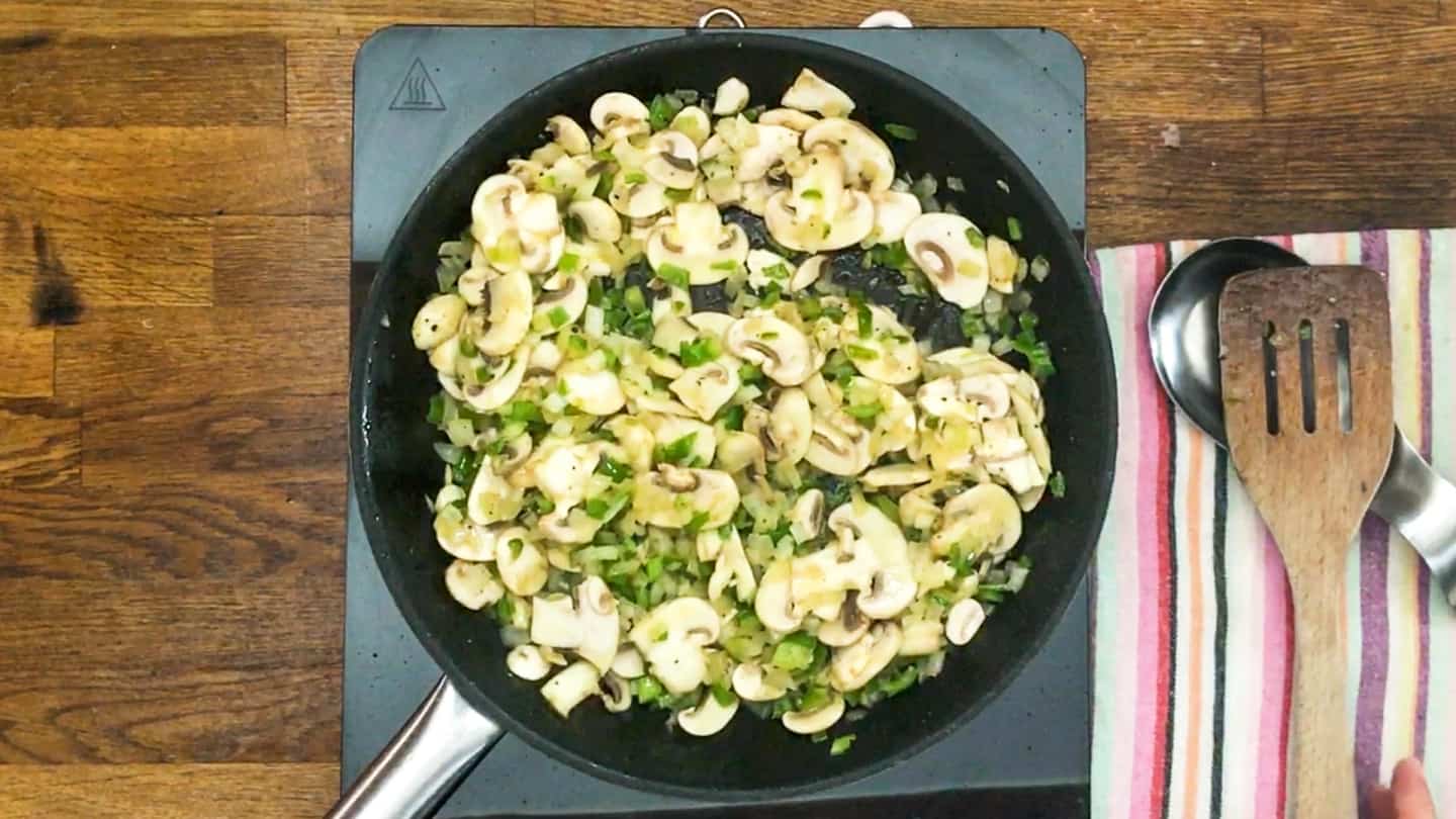 mushrooms and greens cooking in a pan