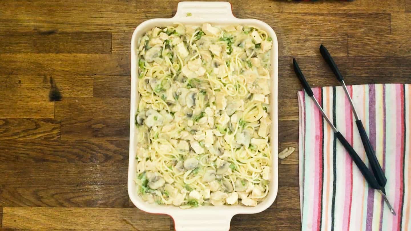 spaghetti into  baking dish, with chicken and creamy sauce