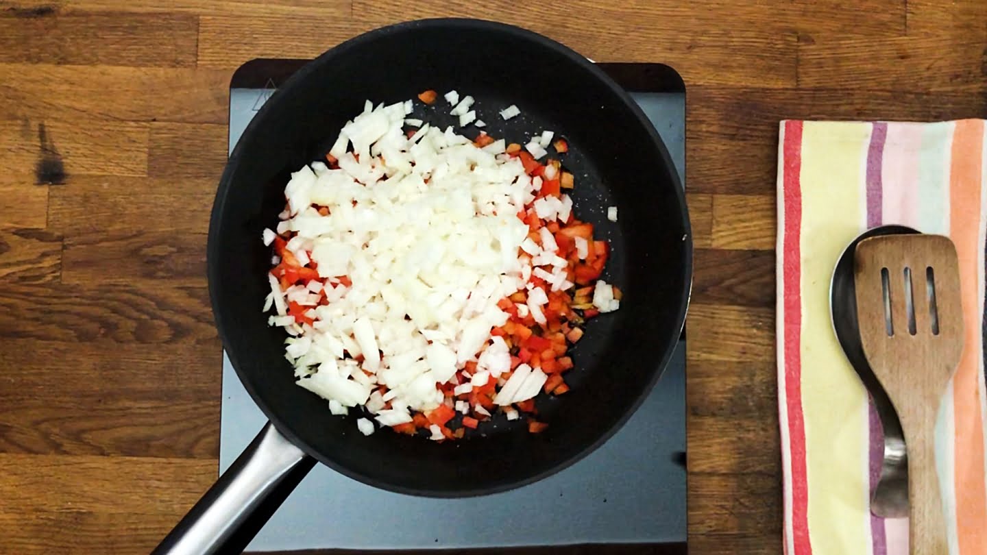 Onion and peppers in skillet