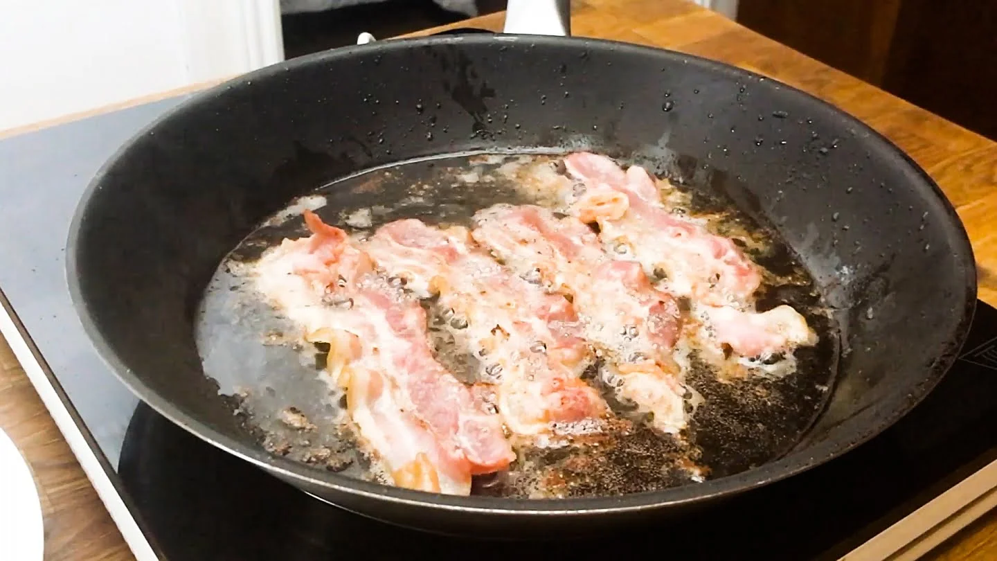 cooking bacon in skillet