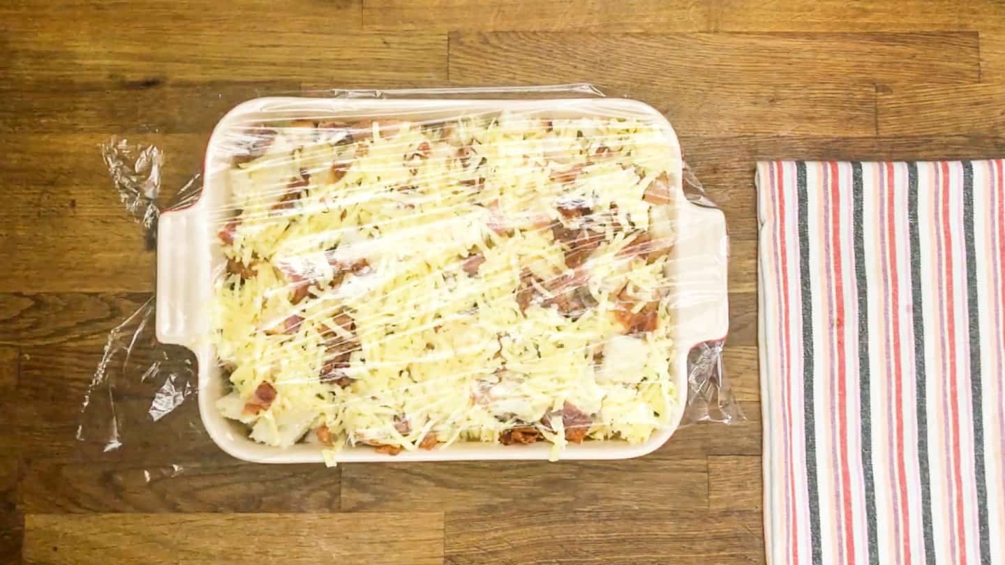 breakfast casserole with bacon covered with plastic wrap