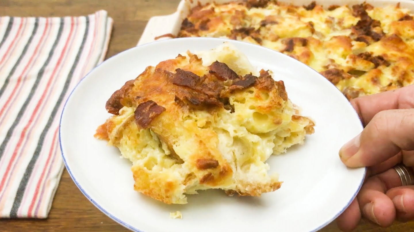  one serving of breakfast casserole with bacon and bread on white plate