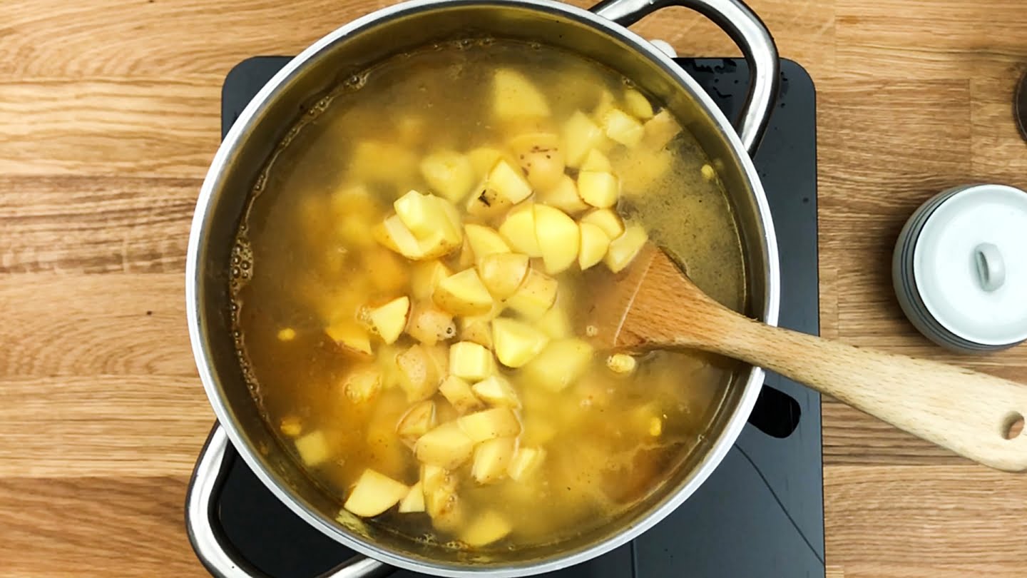 cubes potatoes adding to soup
