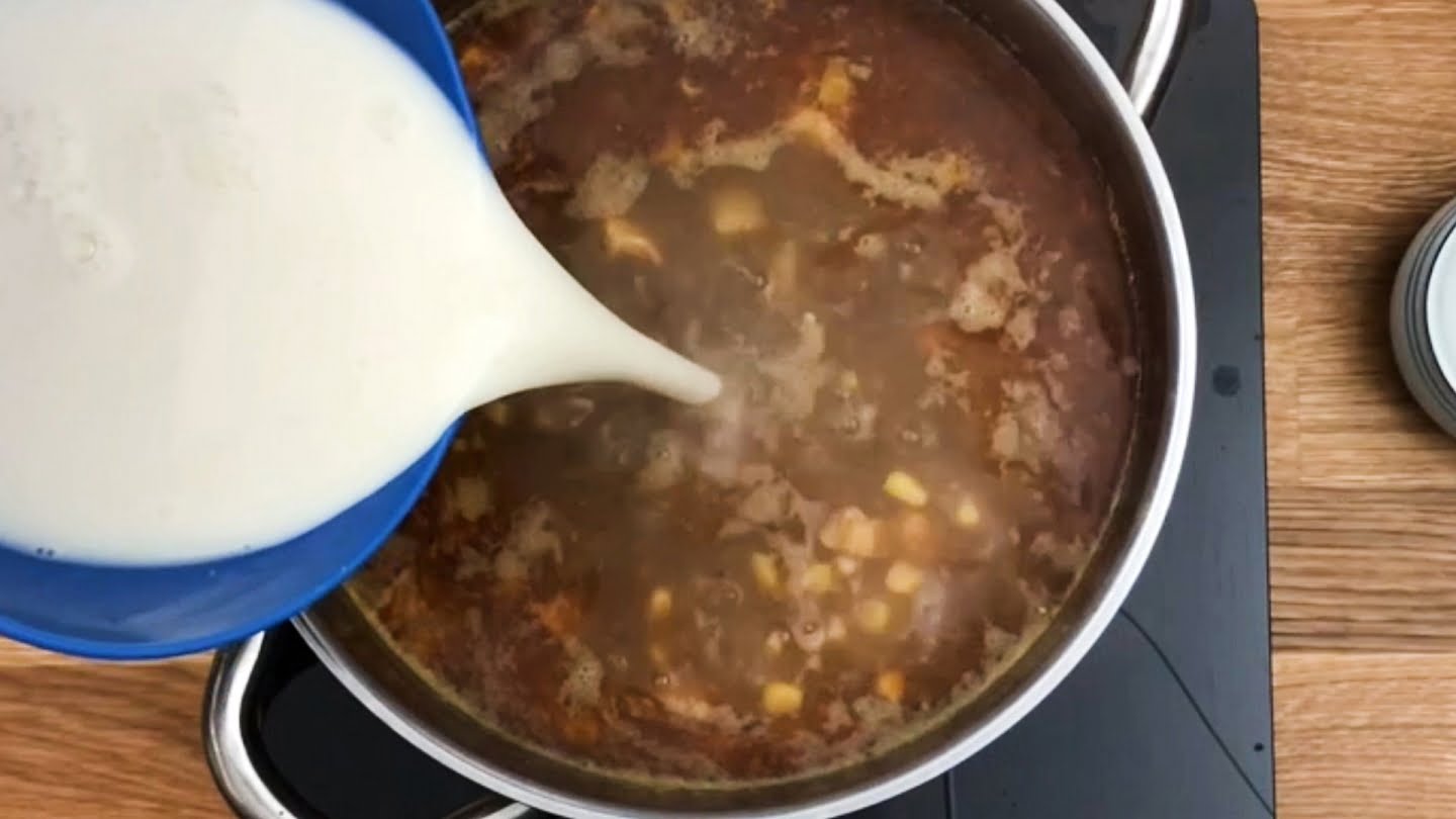 milk mixture pouring into soup