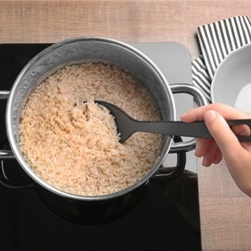 Woman cooking brown rice on stove