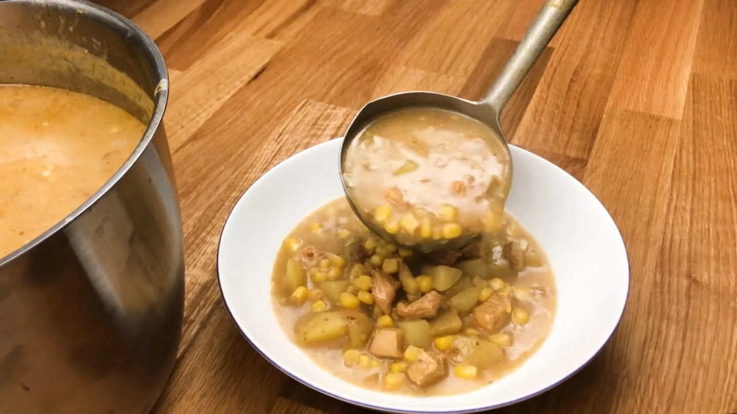  chicken corn chowder soup in a plate with spoon