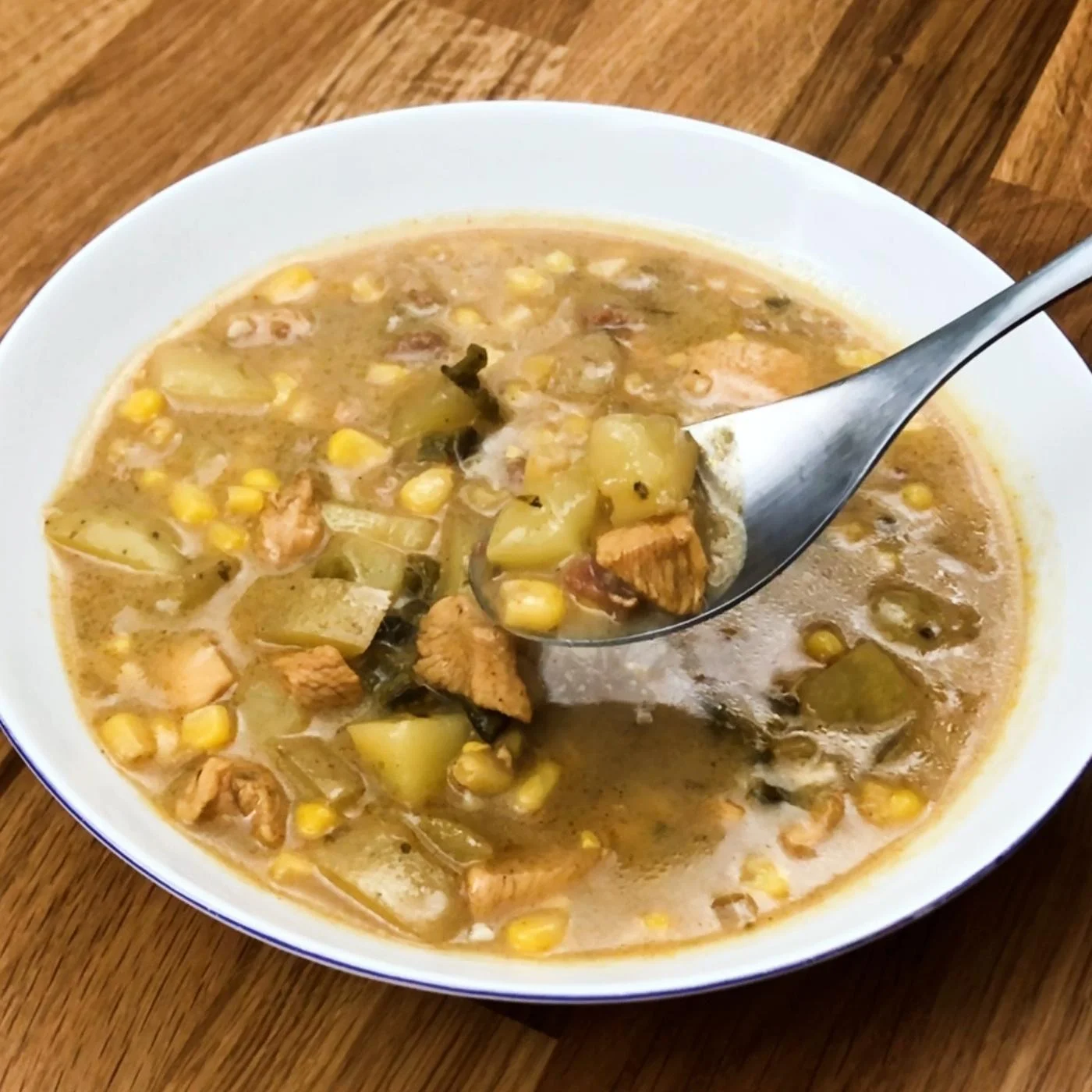  chicken corn chowder soup in a plate with spoon