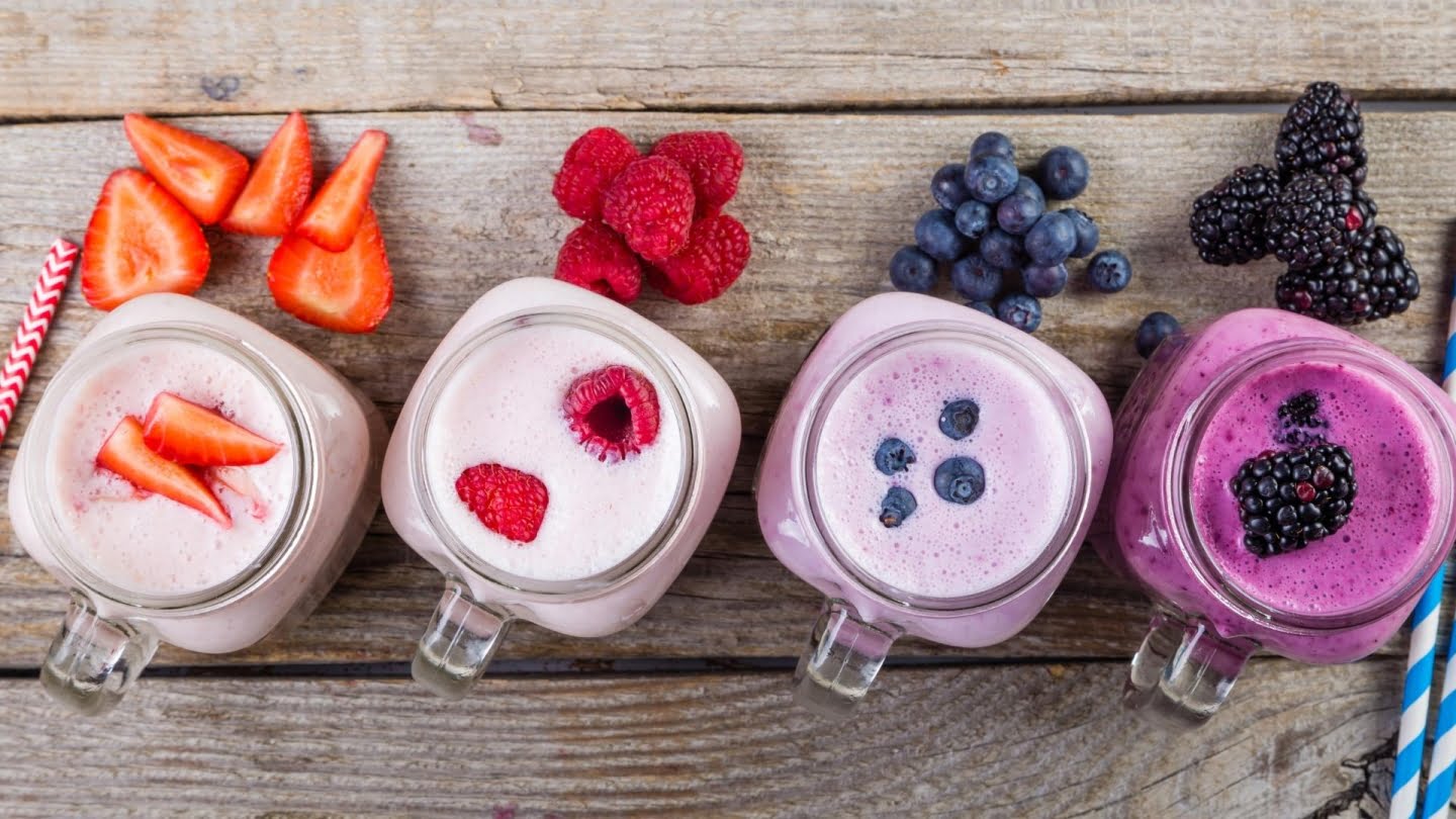 4 fruit milkshake variations from left to right (strawberry, raspberry, blueberry, black berry)
