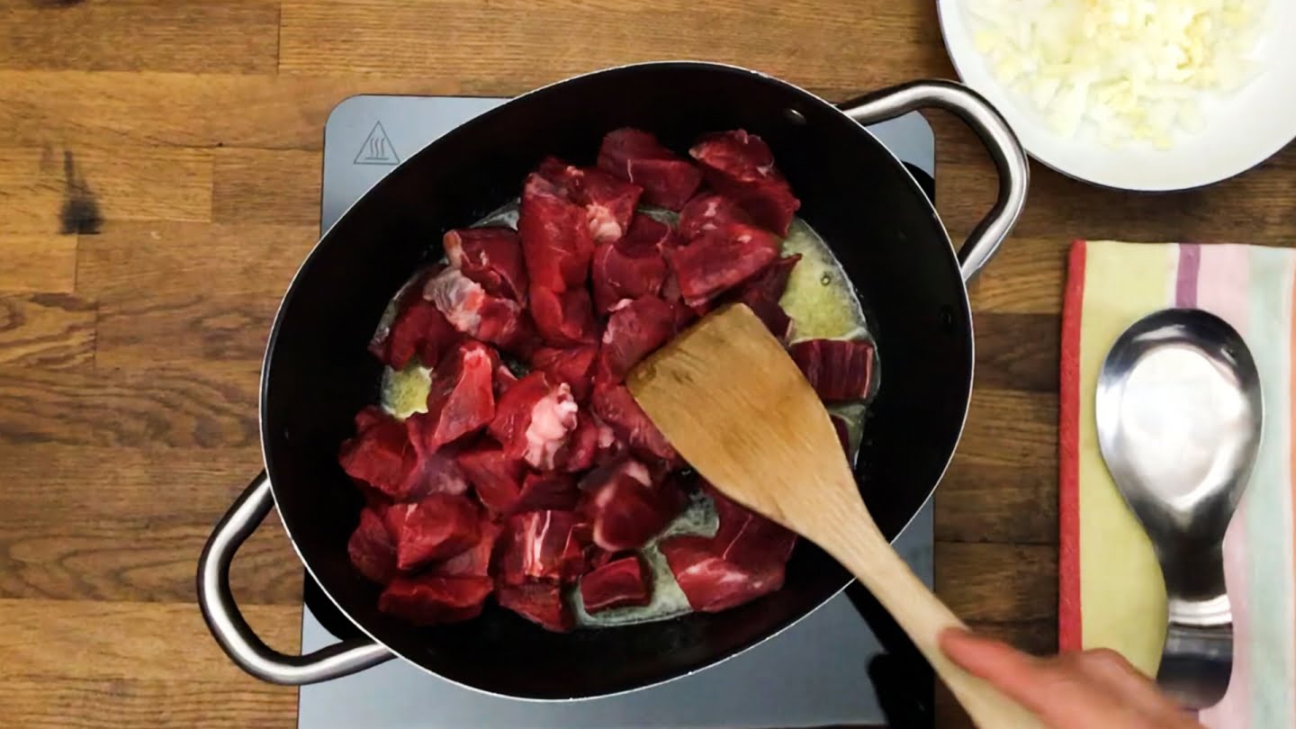 butter over medium heat in a dutch oven and cook the meat