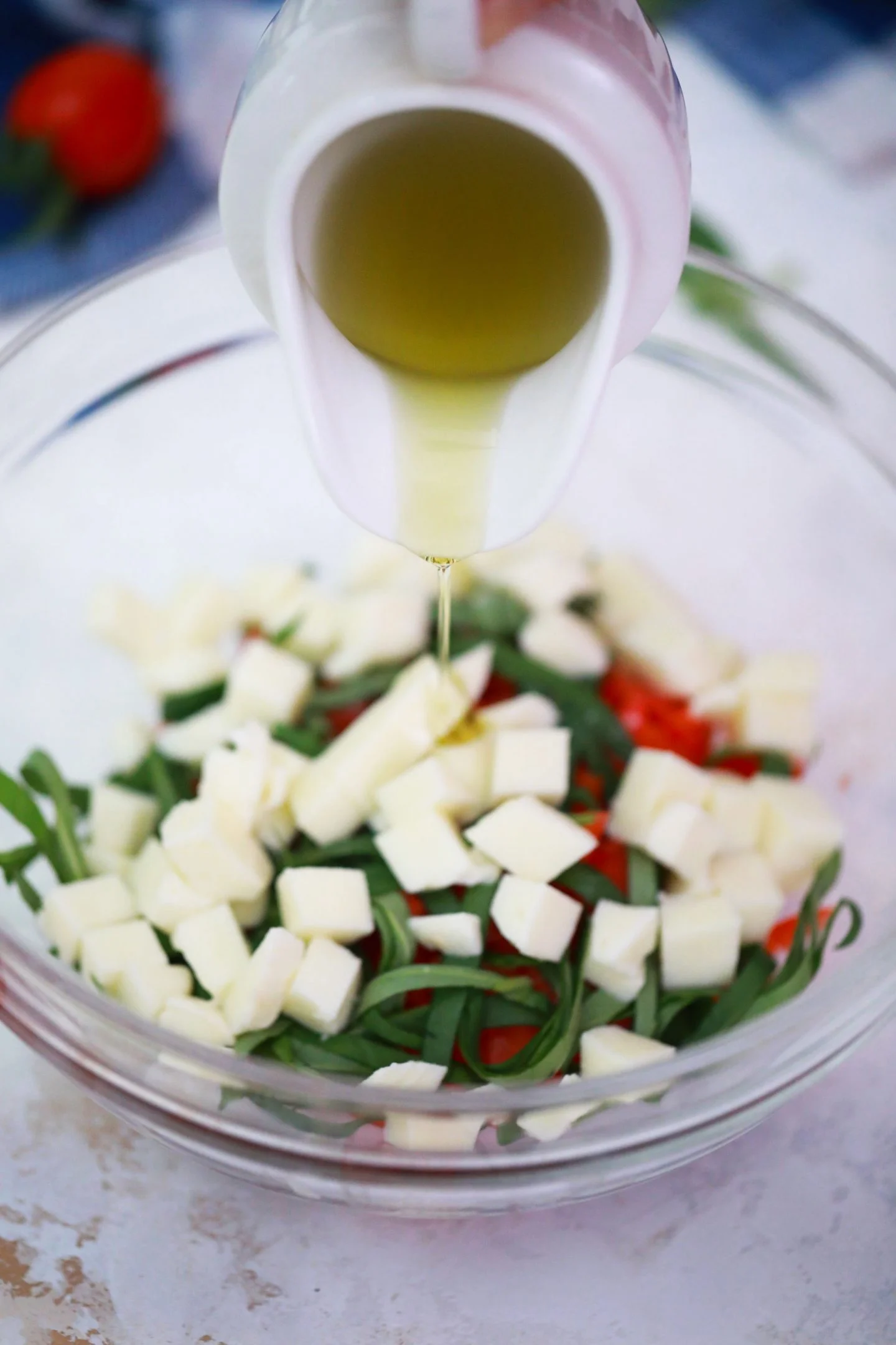 olive oil into bowl with bruschetta mix