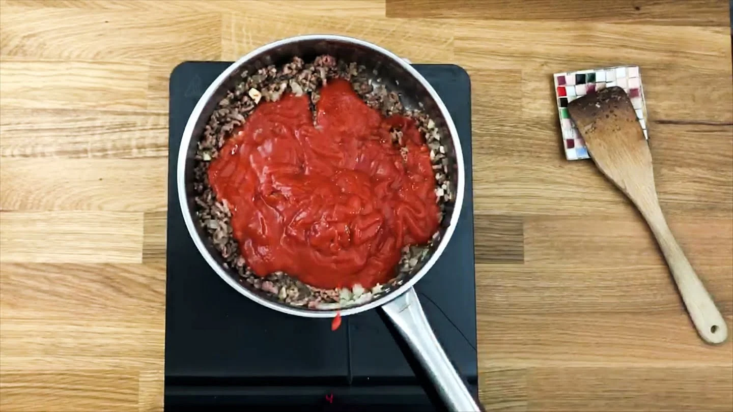 tomato sauce cooking with beef mixture