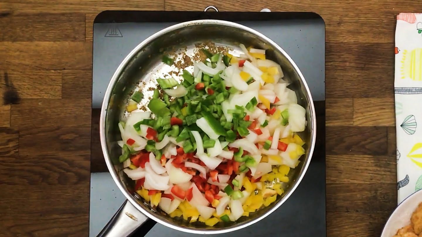 Onions, bell peppers, 1 tablespoon paprika, and cayenne pepper to the pan