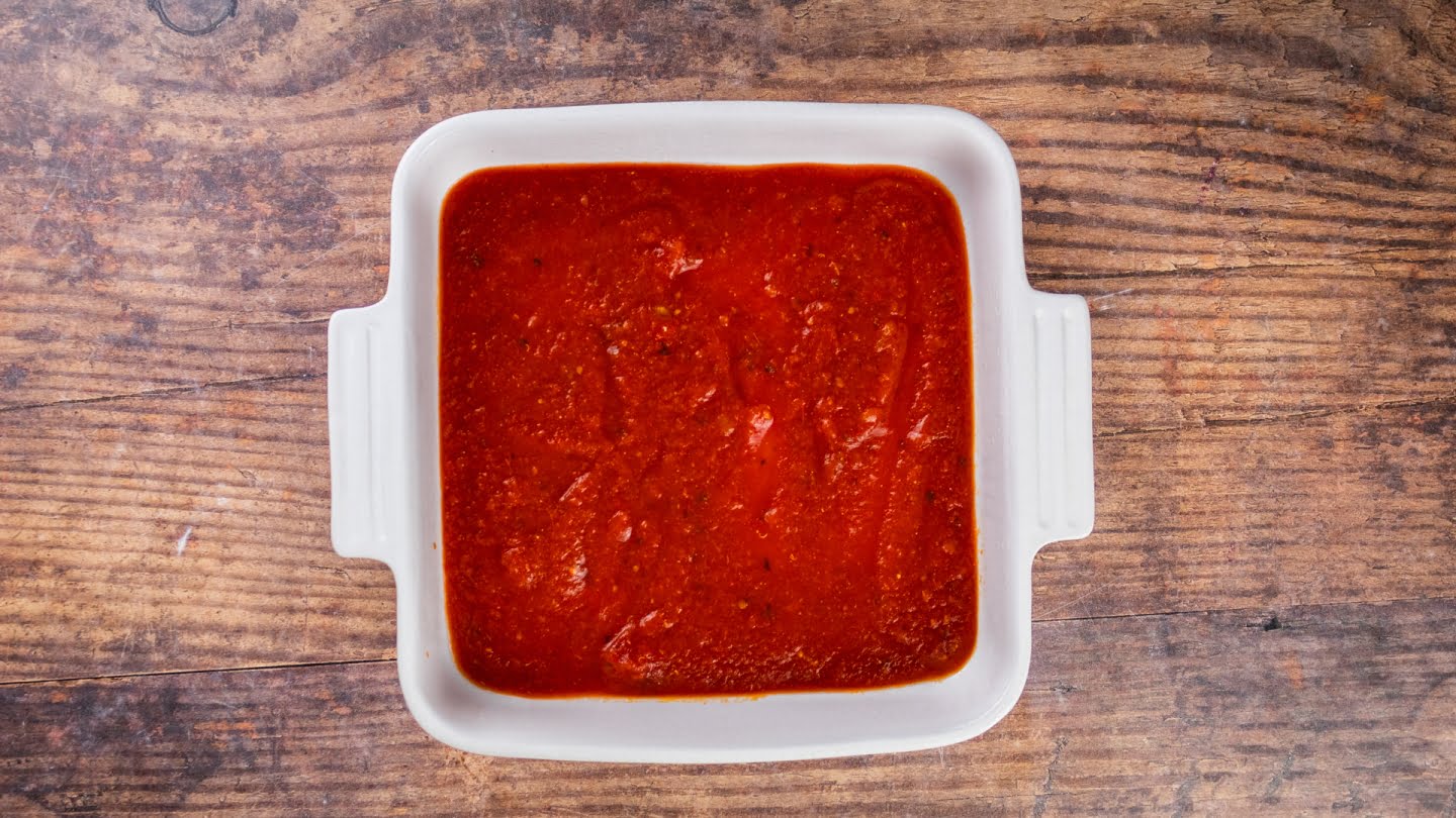 Grease a baking sheet with cooking spray and pour 1 cup of the readymade marinara sauce into it.
