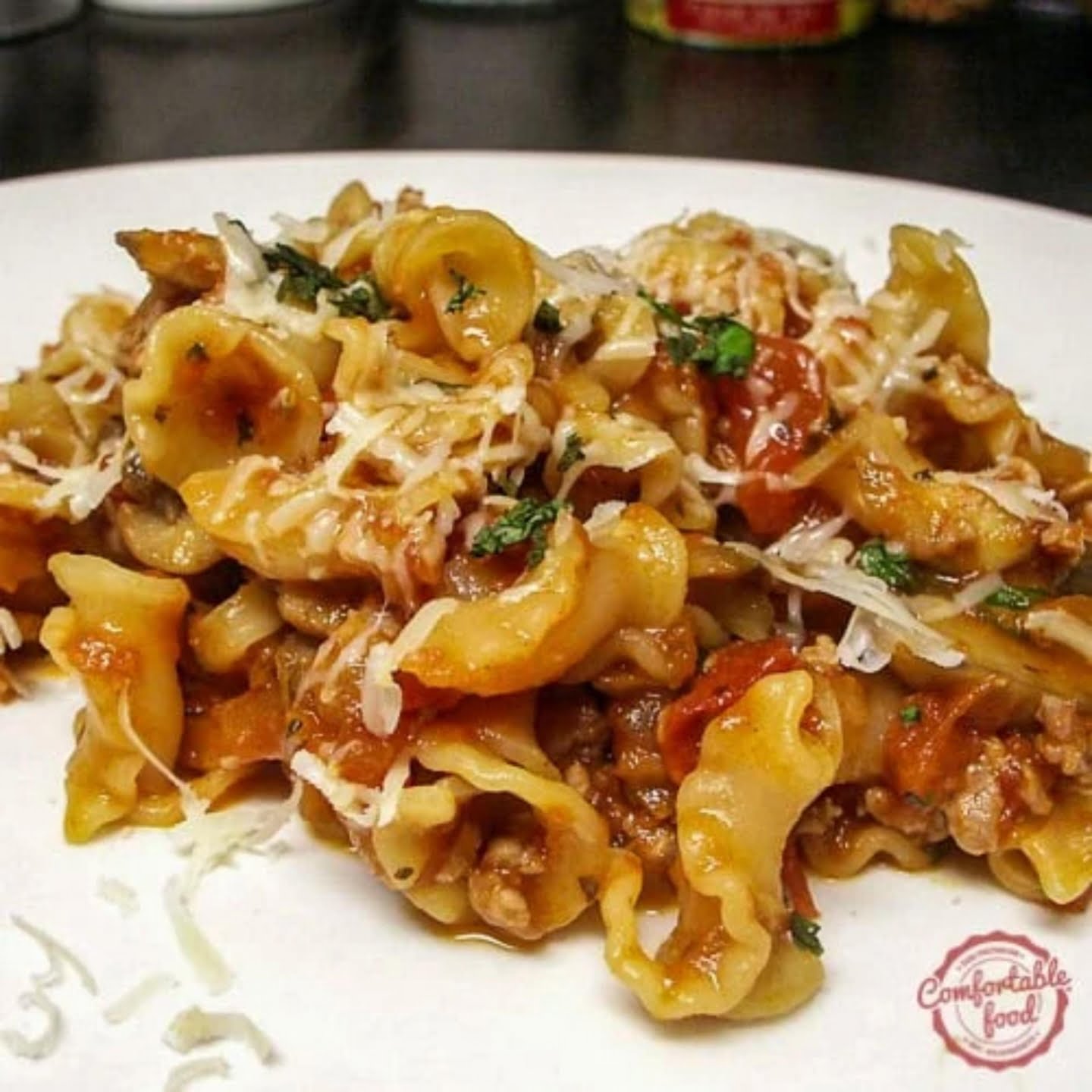 Pasta with sausage, mushrooms, and tomatoes