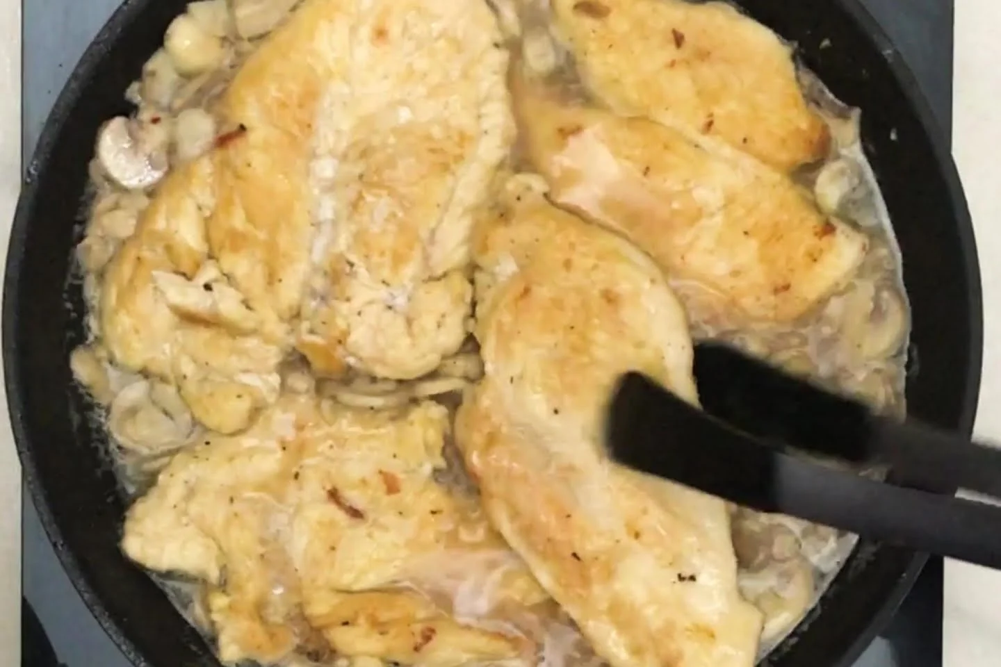 Addition of chicken to the skillet with wine