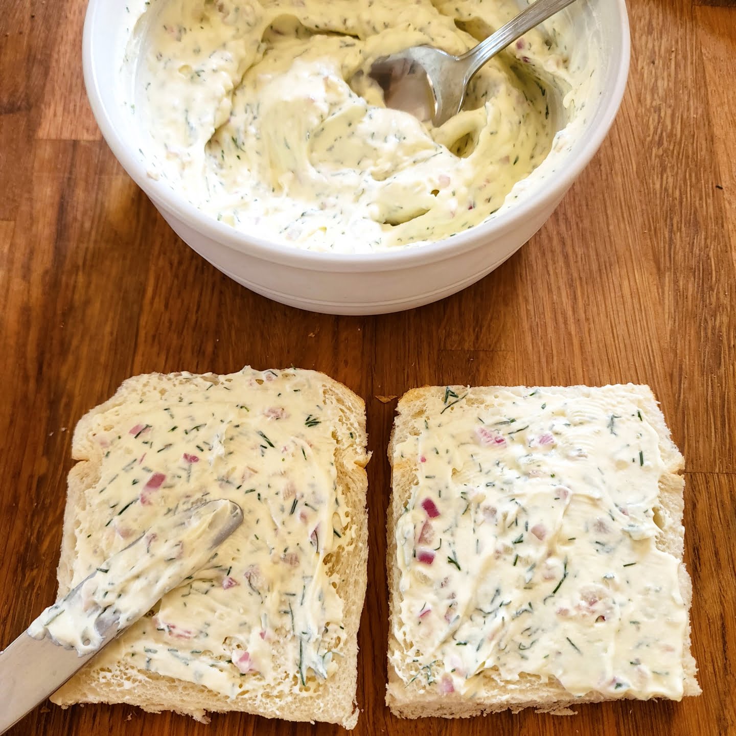 Spreading cream cheese on top of bread
