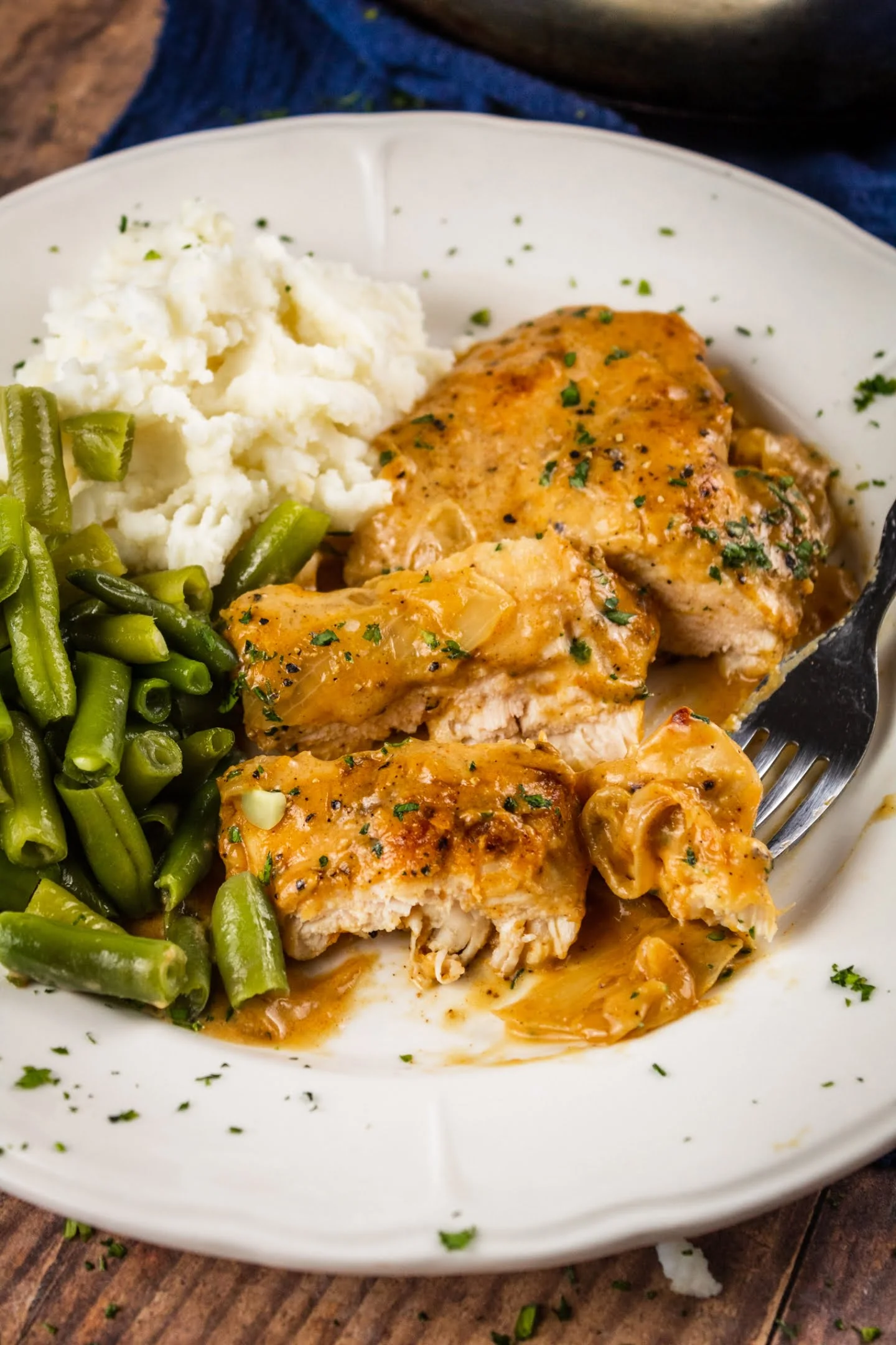 smothered chicken with mashed potato and beans - serving with mashed potato and green beans