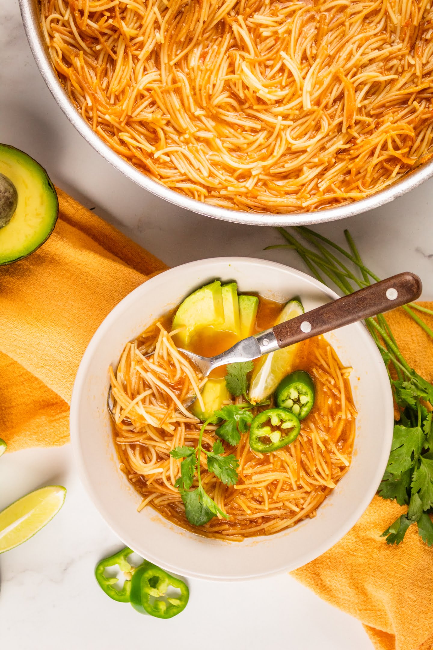 mexican noddle soup with jalapeno limes and avocado