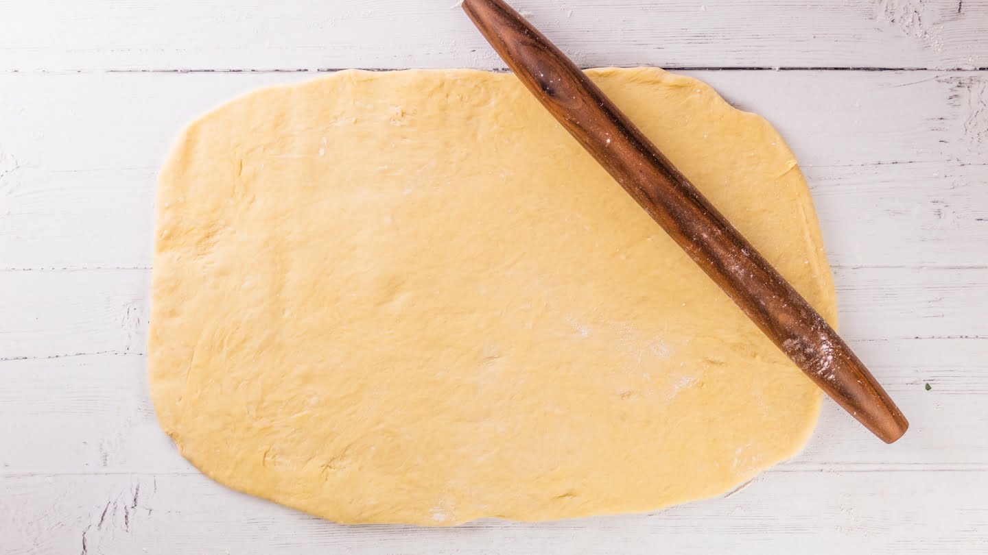 Punch down the soft dough and roll it out on a flat
