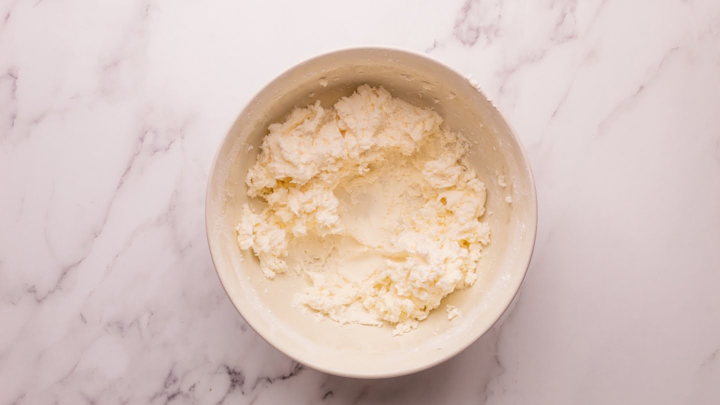Cream together the butter and powdered sugar until light and fluffy in a medium bowl