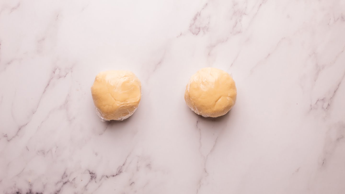 Divide the dough in half, form it into small balls