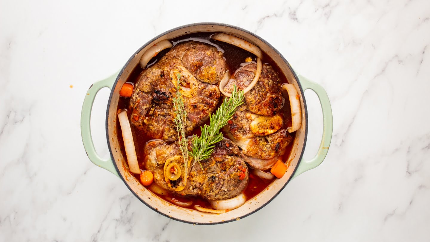 Place the beef shanks back in the Dutch oven along with the drippings from the plate and stir in the other 1 cup broth with the fresh herbs.