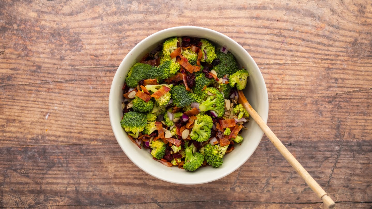 Mix the bacon pieces together with broccoli florets, diced red onion, sunflower seeds, dried cranberries, and almonds in a large bowl.