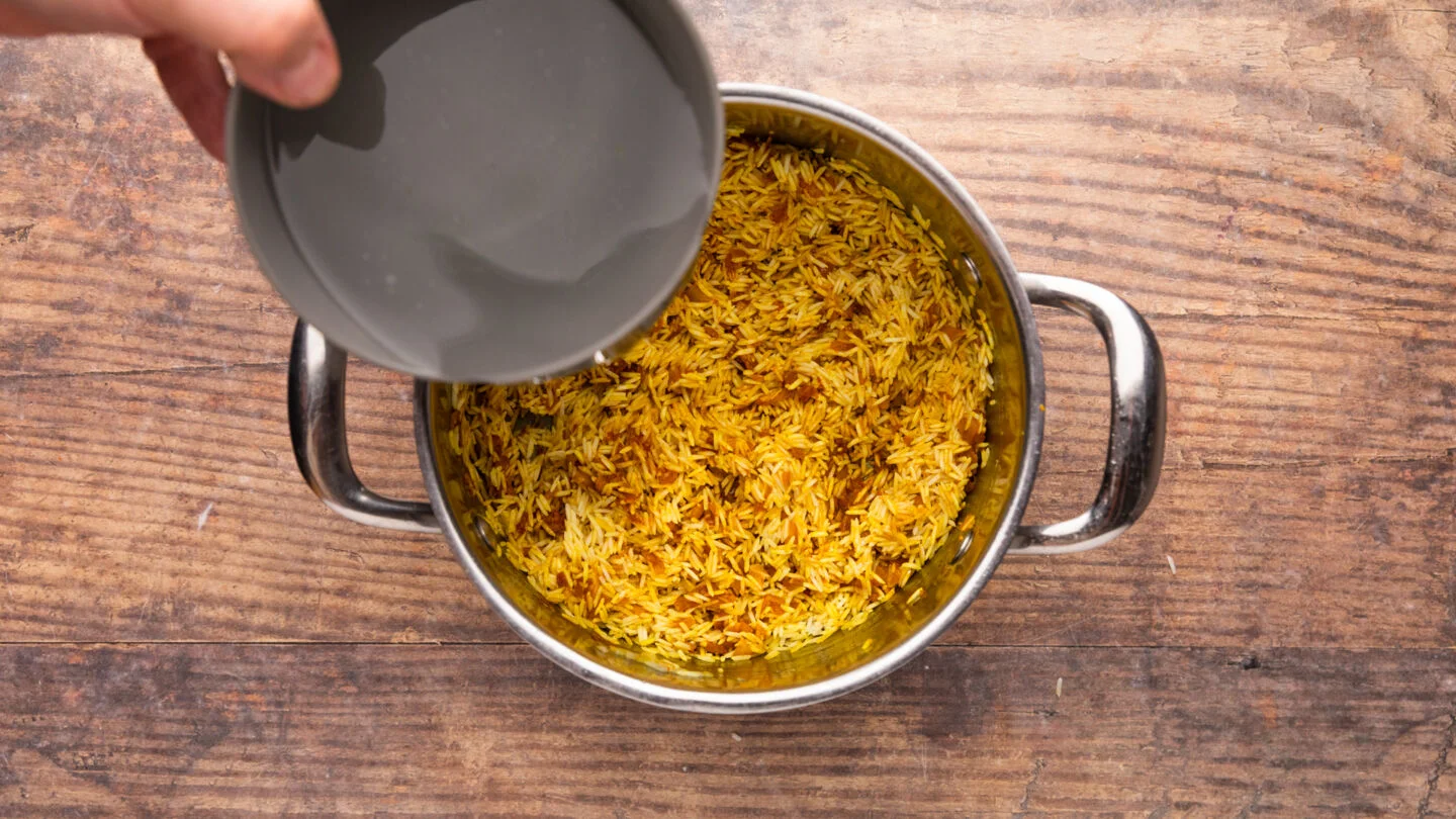 Pour in the water and mix soften onion and spices together