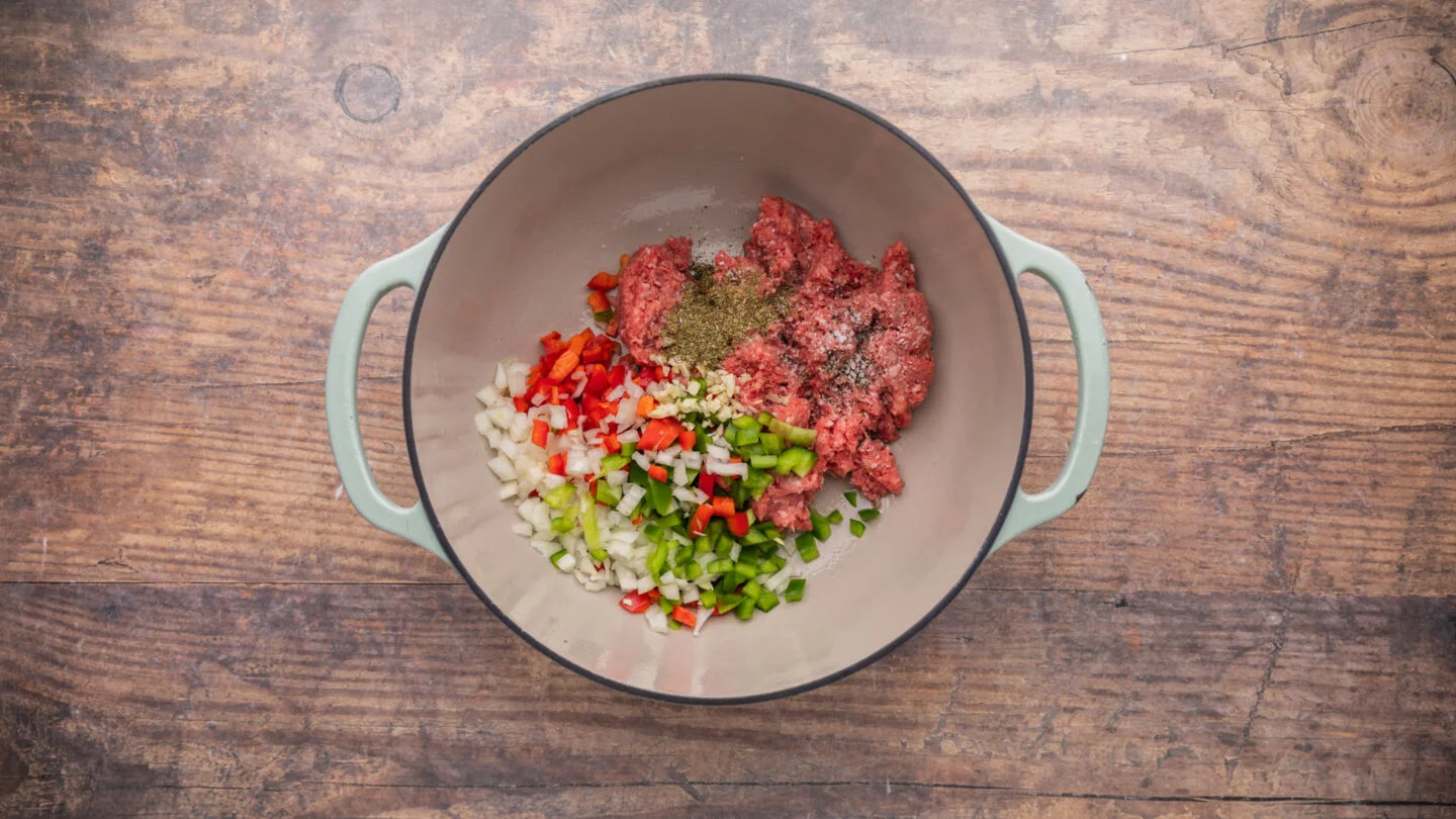 Finely dice the garlic, onion, and bell peppers