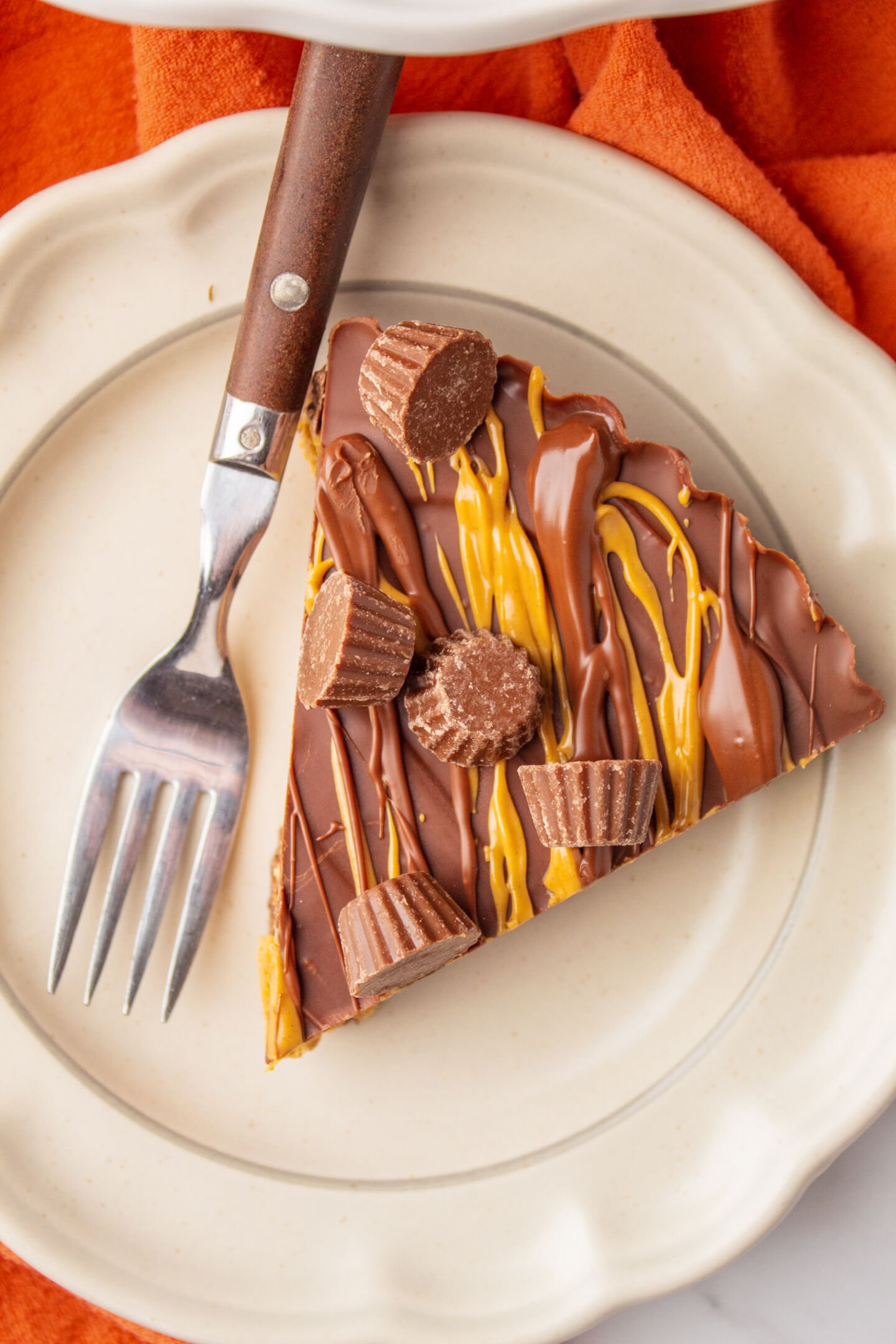 Cut reese's peanut butter pie into slices, serve with whipped cream