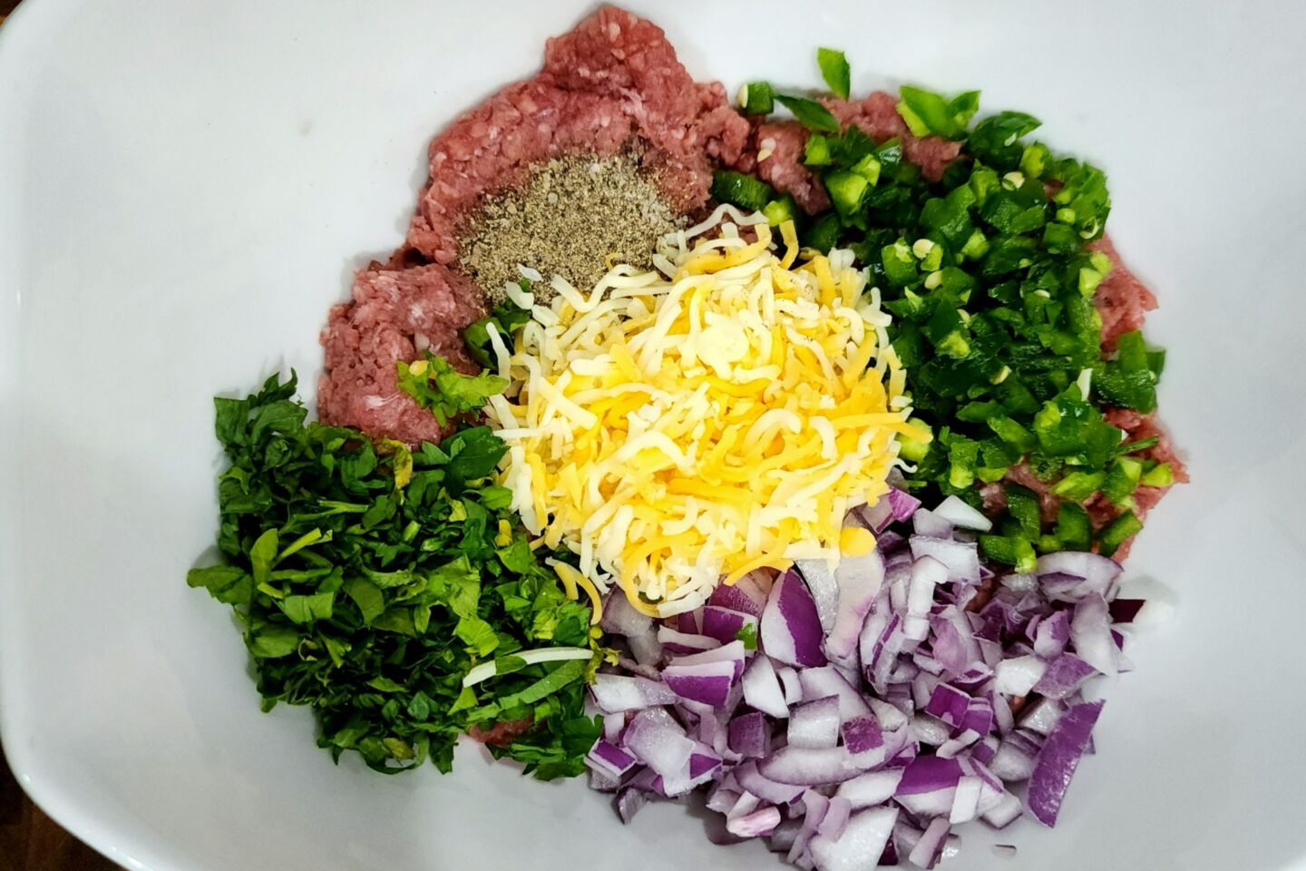 Step 3 Mix the ground beef, chopped onion, cheddar cheese, diced jalapeno, chopped parsley, and salt and pepper in a bowl.